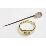 A gentlemen's 18ct gold single stone diamond ring,together with a carved glass stick pin,depicting