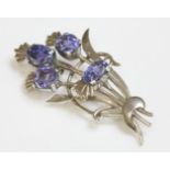 A gold and silver sapphire set spray brooch, c.1950,with four cushion and oval native cut sapphires,