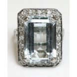 An 18ct white gold, aquamarine and diamond cluster ring,by A A Bond & Sons Ltd.  The rectangular