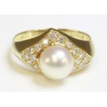 An 18ct gold cultured pearl and diamond ring, by Mikimoto,with a 7.9mm cultured pearl peg set to the