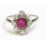 An Art Deco ruby and diamond oval cluster ring,with an oval mixed cut ruby, milligrain set in a