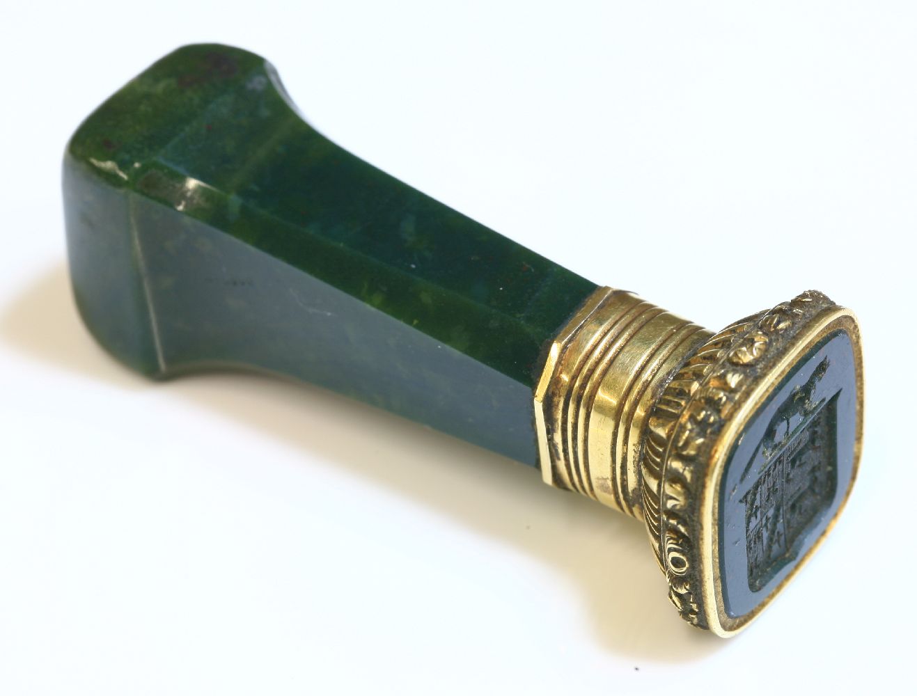 A gold mounted desk seal,with octagonal tapering bloodstone handle and cushion shaped pommel.