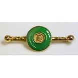 A Chinese jade gold brooch,with a jade bi rub set to the centre, with Chinese characters to the