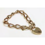 A 9ct gold open curb link bracelet,with a large padlock clasp, marked 15.  Safety chain broken