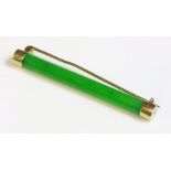 A jade bar brooch, early 20th century,by Wang Hing & Co., with a circular section jade baton, to a