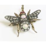 An Edwardian opal and diamond bee brooch,with cabochon ruby eyes, the thorax composed of a