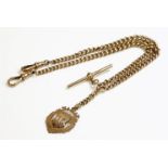 A 9ct gold double Albert chain,with two rows of graduated curb chain with a 9ct gold shield fob to