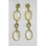 A pair of gold aquamarine and moonstone drop earrings,with round mixed cut aquamarines, rub set in