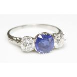 An early 20th century sapphire and diamond three stone ring,with a circular mixed cut sapphire