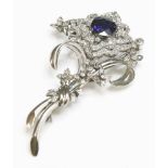 A sapphire and diamond spray brooch, c.1950,with a main flower head composed of a circular mixed cut