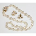 A single row cultured pearl necklace,with an 18ct gold cultured pearl and diamond clasp, a single