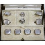 A cased Art Deco white gold mother-of-pearl dress stud set,with a cushion shaped pair of