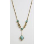 An Edwardian turquoise and diamond pendant,with a 'Y' shaped centrepiece composed of two laurel