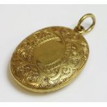 A late Victorian gold locket,of oval hinged form, with hand engraved decoration to both sides.