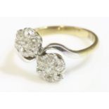 A double cluster diamond crossover ring, early 20th century,with old Swiss cut and old eight cut