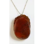 A Chinese carved amber pendant,of a gourd and fruiting vine, later mounted on a gold jump ring,