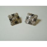 A pair of 9ct gold noughts and crosses stud earrings, set with diamonds and black stones