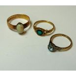 An 18ct gold green paste ring, a 9ct gold blue zircon single stone ring, and a 15ct gold band