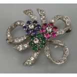 A sterling silver synthetic spinel bow brooch, circa 1960, with three central clusters of