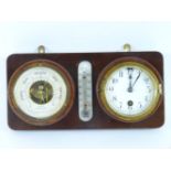 A wall mounted clock and barometer, inscribed W Ludolph AG, Hamburg, separated by a thermometer,