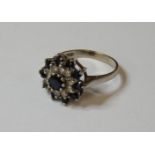 An 18ct white gold sapphire and diamond circular cluster ring