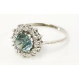 An 18ct white gold blue zircon and diamond cluster ring