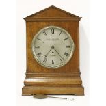 A 19th century oak bracket clock, in an architechtural case, the silvered dial inscribed 'Barraud