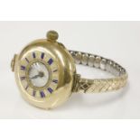 An 18ct gold ladies early mechanical wristwatch, of half hunter fob watch style, later rolled gold