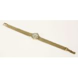 A ladies 9ct gold Tissot mechanical bracelet watch