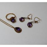 A 9ct gold amethyst pendant, a gold amethyst ring, and a pair of 9ct gold amethyst drop earrings