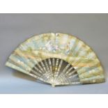 A 19th century Continental painted fan, with figure amongst parkland, the reverse with hills and a