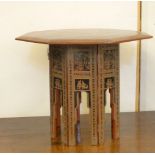 An octagonal folding Indian lacquer table, 50cm high, 61cm across