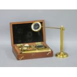 A travelling brass monocular microscope, with three multiple slides, in mahogany case/stand, and a