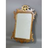 A walnut and parcel gilt wall mirror, the top surrounded with a pierced panel with a ho-ho bird