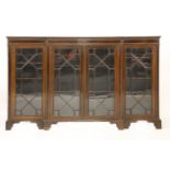 An Edwardian mahogany low breakfront bookcase, with strung and crossbanded decoration and four