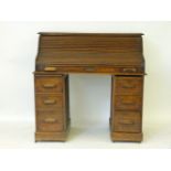 A 1920s oak roll top desk, 123cm wide