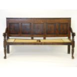 A George III oak and mahogany crossbanded settle, with five panel back, with hardwood seat, 186cm