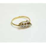 An Art Deco five stone diamond crossover ring, with diamond set shoulders, finger size O½