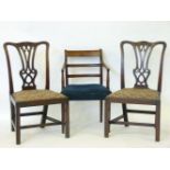 A pair of mahogany side chairs, with well carved pierced backs, drop-in seats, and an elbow chair