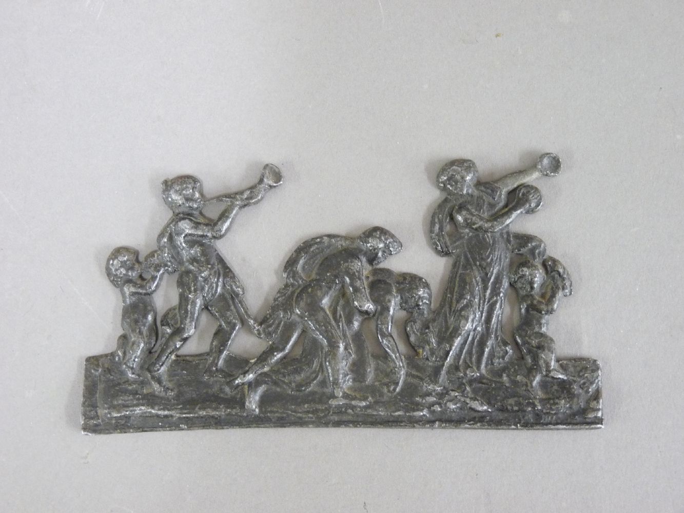 An Italian lead appliqué of a Bacchanal, probably 16th/17th century, 13.5cm long, ex Richard