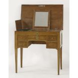 A Continental walnut inlaid dressing table, the hinged top over a central mirror, and two lidded