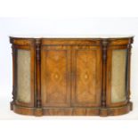 A Victorian inlaid walnut credenza, gilt mounted, the central cupboard flanked with bow glazed