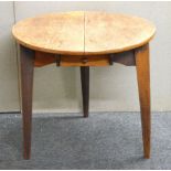 An antique circular elm cricket table, 29cm diameter
