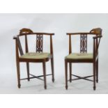 A pair of Edwardian strung and inlaid mahogany carver chairs