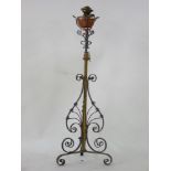 An Arts & Crafts wrought iron, copper and brass adjustable standard lamp, circa 1900, 137cm high,