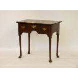 A Georgian walnut and yew wood lowboy, the rectangular top fitted above a frieze of three drawers,