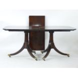 An Arthur Brett twin pedestal dining table