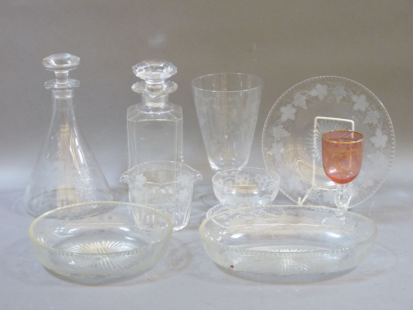 A quantity of Edwardian etched glassware, to include glass plates, decanters, rinsers, etc