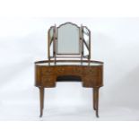A reproduction walnut kidney shaped dressing table, fitted with an arrangement of five drawers, on