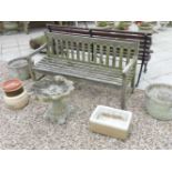 A wooden garden bench, a composition bird table, and a selection of garden tubs